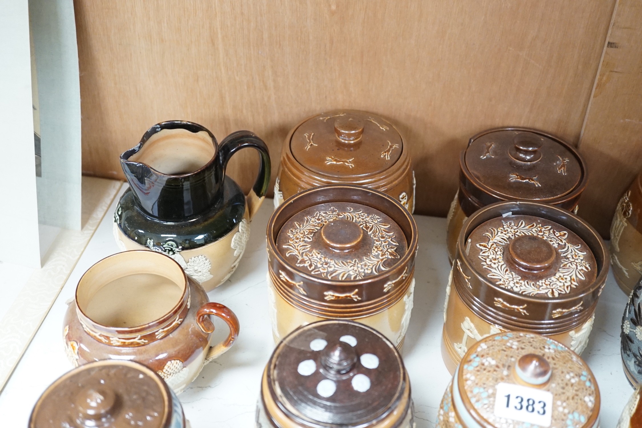 A quantity of Doulton stoneware tobacco jars and jugs